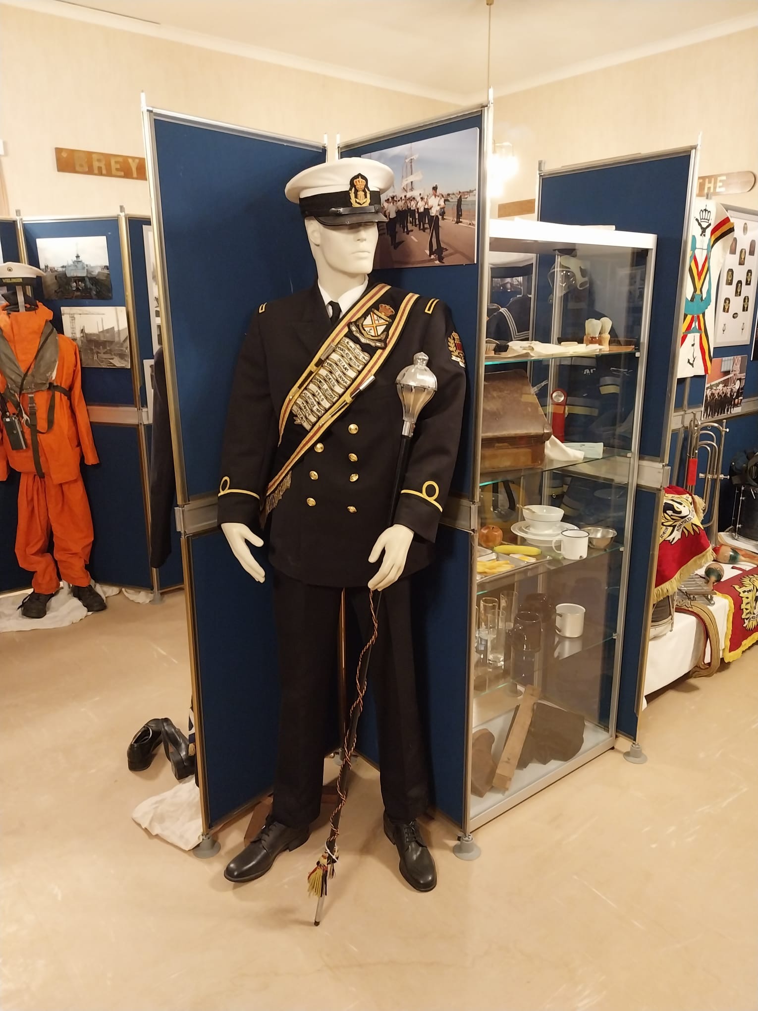 Museum display case with naval artifacts